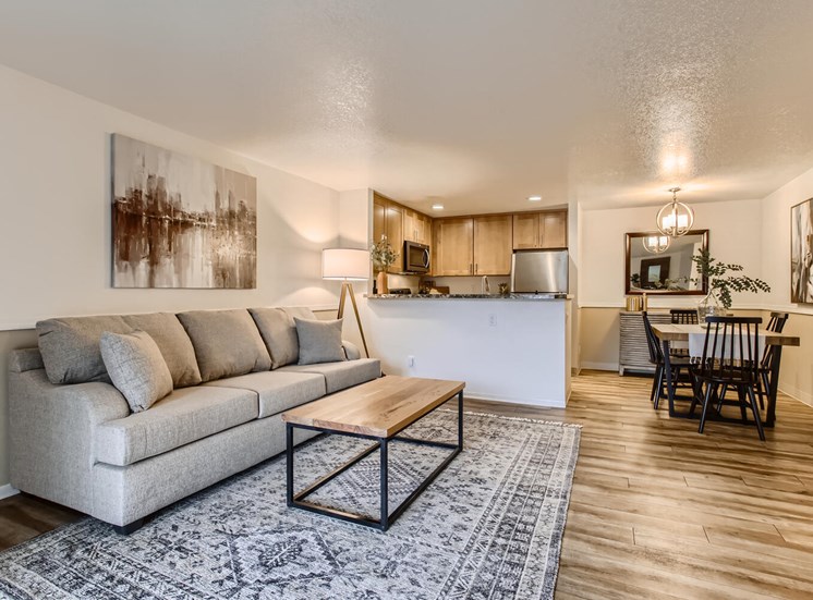 Lake Oswego, OR Apartments for Rent - Westlake Meadows - Living Room with Grey Couch, Open Layout, and Large Area Rug
